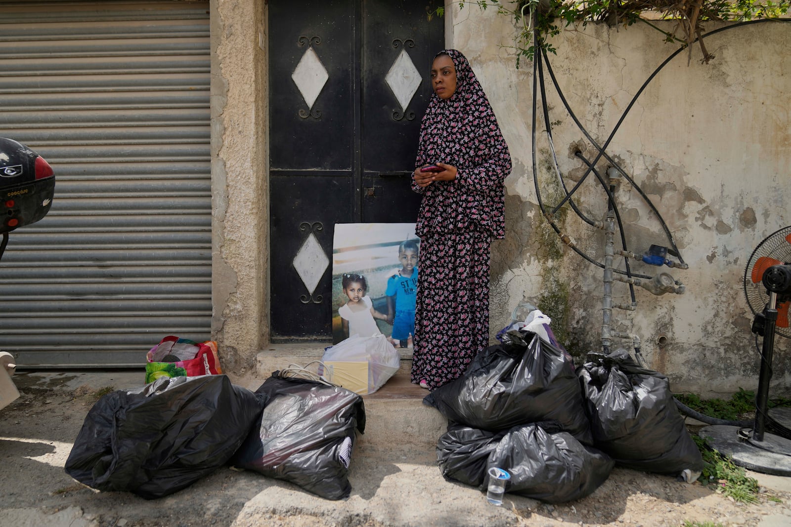Residents of the now evacuated refugee camp of Tulkarem return to collect belongings before the destruction of their homes as Israeli forces prepare to carry out the demolition of 116 homes across the two refugee camps of the Israeli occupied West Bank city of Tulkarem, Friday, May 2, 2025. (AP Photo/Nasser Nasser)