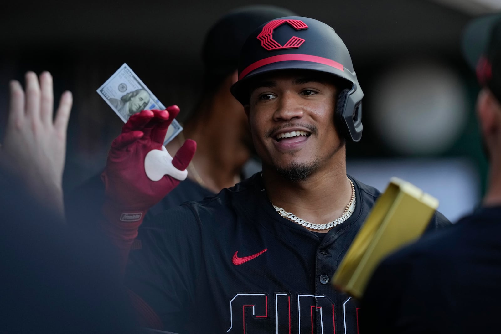 Cincinnati Reds' Noelvi Marte celebrates in the dugout after hitting a solo home run during the third inning of a baseball game against the Colorado Rockies in Cincinnati, Friday, July 11, 2025. (AP Photo/Carolyn Kaster)