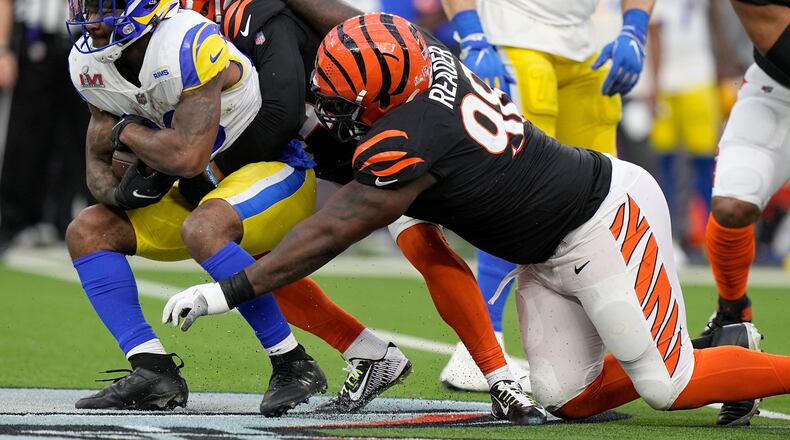 Los Angeles Rams running back Cam Akers, left, is tacked by Cincinnati Bengals strong safety Vonn Bell, middle, and nose tackle D.J. Reader during the first half of the NFL Super Bowl 56 football game Sunday, Feb. 13, 2022, in Inglewood, Calif. (AP Photo/Lynne Sladky)