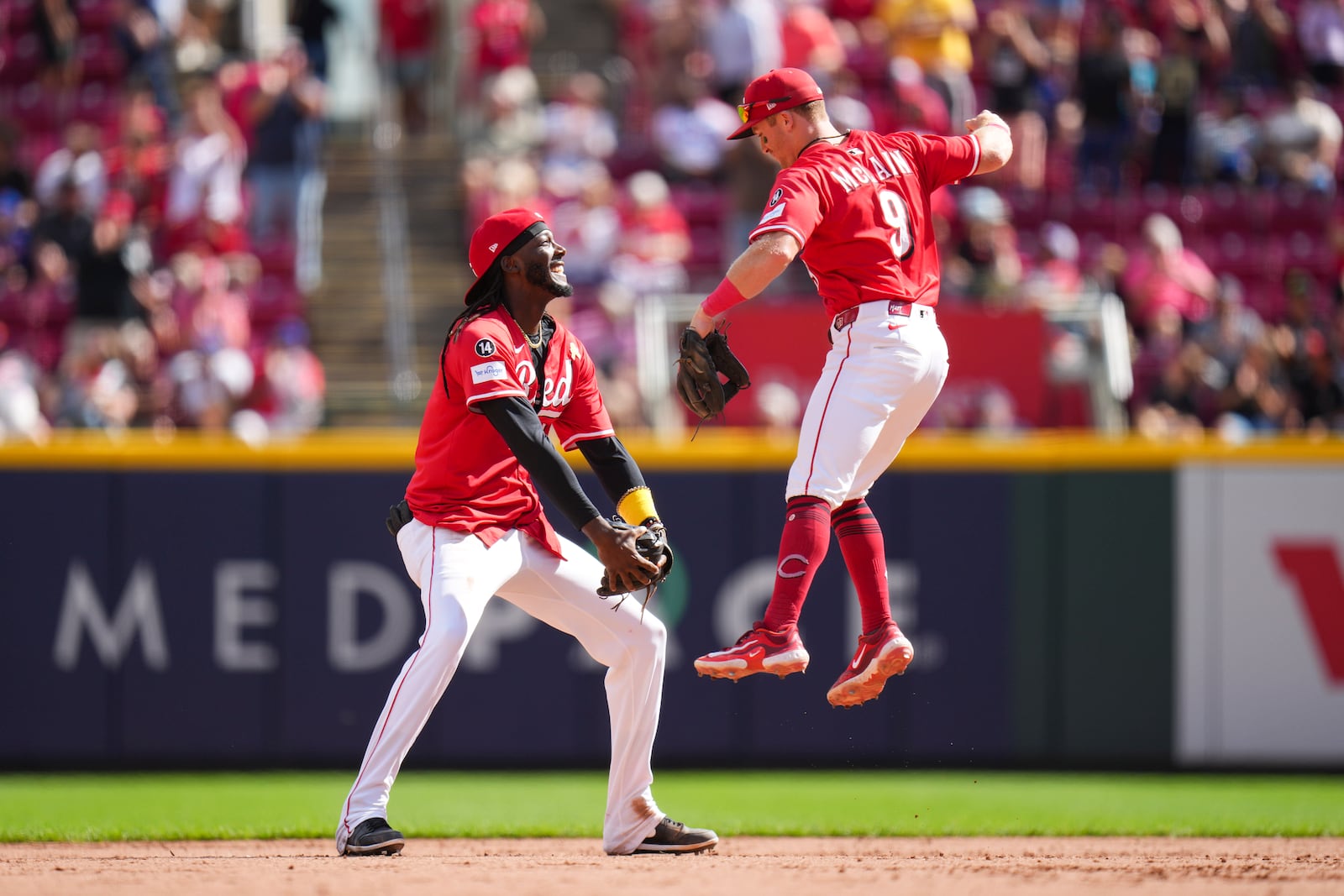 Cincinnati Reds' Matt McLain (9) celebrates with teammate Elly De La Cruz, left, following a baseball game against the New York Mets, Sunday, Sept. 7, 2025, in Cincinnati. (AP Photo/Jeff Dean)