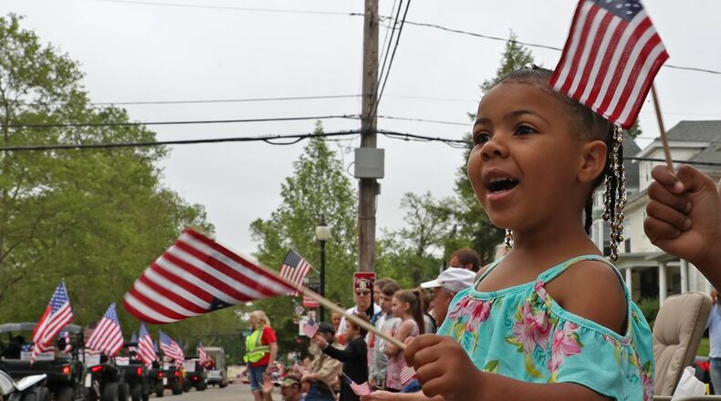 A young paradegoer waves her flag along Fountain Avenue as the 2019 Springfield Memorial Day Parade passes by Monday. BILL LACKEY/STAFF