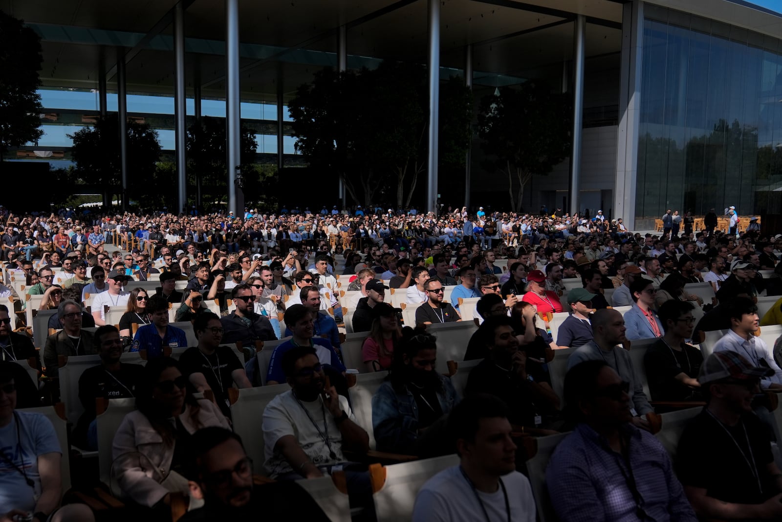 Attendees watch a presentation during an event on the Apple campus in Cupertino, Calif., Monday, June 9, 2025. (AP Photo/Jeff Chiu)