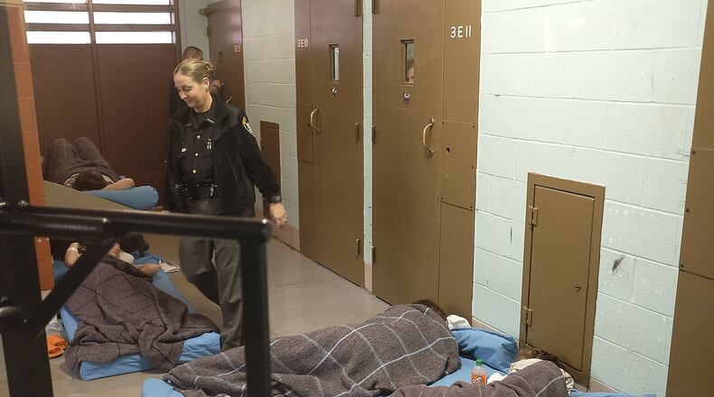 A Clark County Sheriff's deputy steps over female inmates sleeping on the floor of an over crowded cell block Thursday. Bill Lackey/Staff