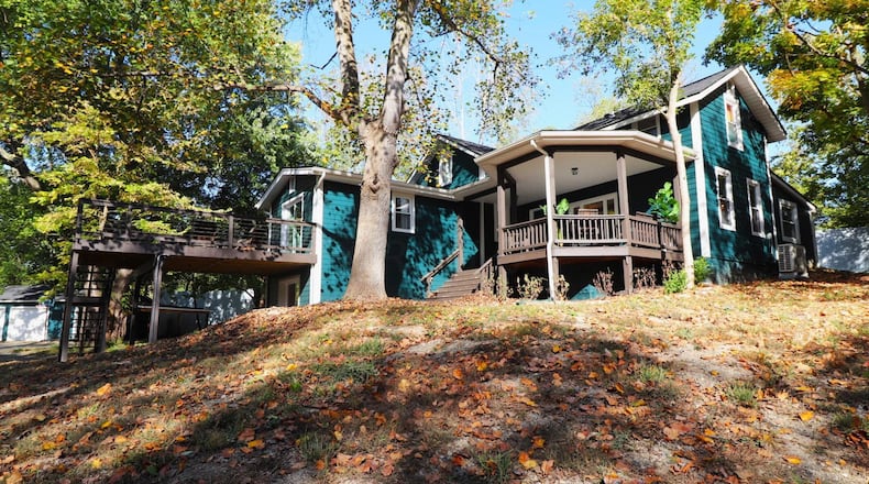The front of the home features a covered porch with gazebo and wood railings. It has newly painted wood siding. Contributed photos