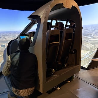 Participants in a Sinclair Community College ground school at Springfield-Beckley Municipal Airport take a "ride" on a simulator meant to impart the experience of flying a Beta Technologies electric plane on Thursday, Feb. 5, 2026. THOMAS GNAU/STAFF