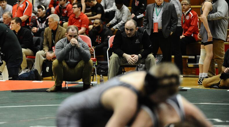 First-year Graham coach Travis McIntosh (upper left) watches as freshman Nolan Geesler wins his match at 106 pounds. Greg Billing / Contributed