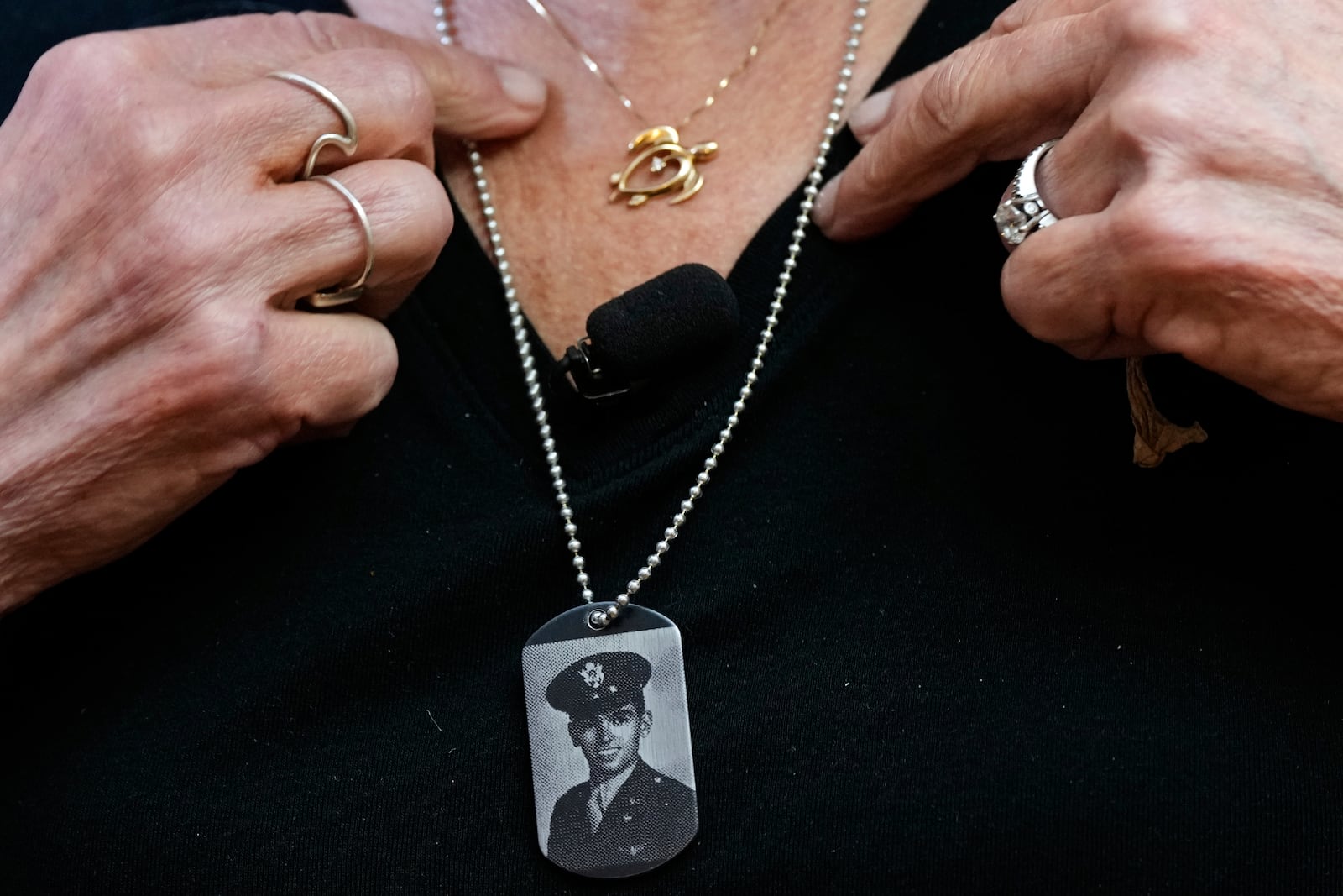 Diane Christie wears a necklace with a photograph of her uncle, World War II U.S. Army Air Forces 2nd Lt. Thomas Kelly, inside Santos Robinson Mortuary, Friday, May 23, 2025, in San Leandro, Calif. whose remains had been missing since being killed when the World War II bomber nicknamed Heaven Can Wait was hit by anti-aircraft fire and crashed into the water off the coast of New Guinea on March 11, 1944. (AP Photo/Godofredo A. Vásquez)