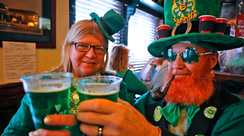 Vicky and Stan Snyder toast to St. Patrick's Day with glasses of green beer Friday, March 17, 2023 at O'Conner's Irish Pub in Springfield. BILL LACKEY/STAFF