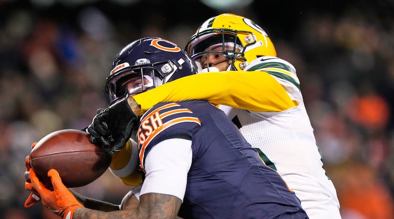 Chicago Bears' DJ Moore catches a touchdown pass with Green Bay Packers' Keisean Nixon defending during overtime of an NFL football game Saturday, Dec. 20, 2025, in Chicago. (AP Photo/Nam Huh)