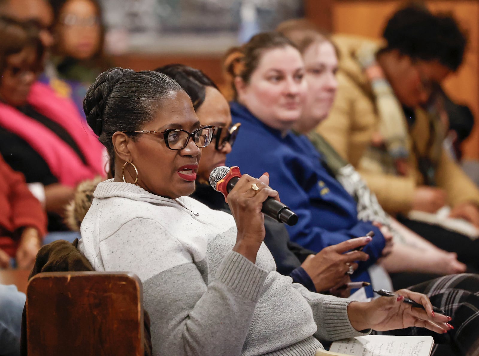 Deidra Reese answers a question asked by a speaker during a community safety meeting "Be a Neighbor: Building a Better Springfield for All" hosted by the Amos Project on Thursday, Jan. 29, 2026, at Zion Hill Baptist Church. Organizers gathered to share tools and guidance with expected ICE activity after the Temporary Protected Status expires on Tuesday, Feb. 3, 2026. JOSEPH COOKE/STAFF