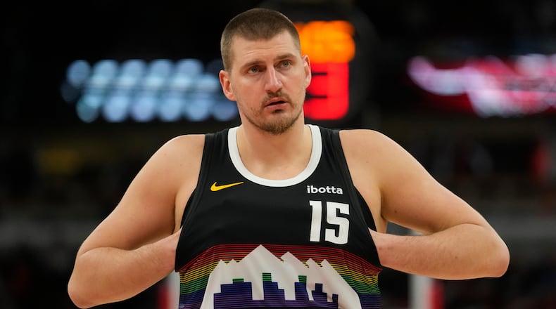 Denver Nuggets center Nikola Jokic (15) sticks his hands in his jersey during the second half of an NBA basketball game against the Chicago Bulls, Saturday, Feb. 7, 2026, in Chicago. (AP Photo/Erin Hooley)