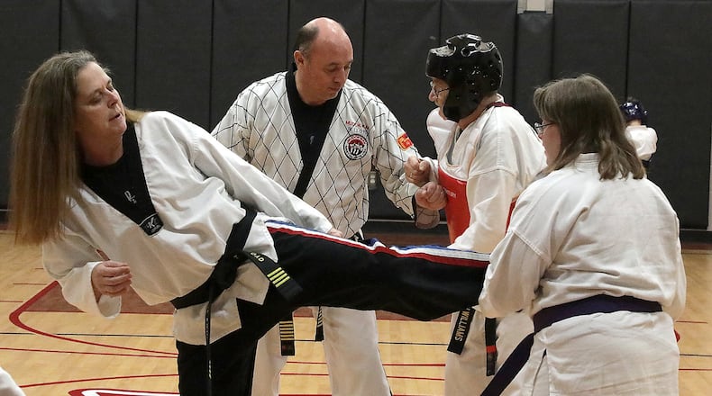 Rick and Tarole Lloyd work with students in their Tae Kwon Do class at the Springfield Salvation Army. BILL LACKEY/STAFF