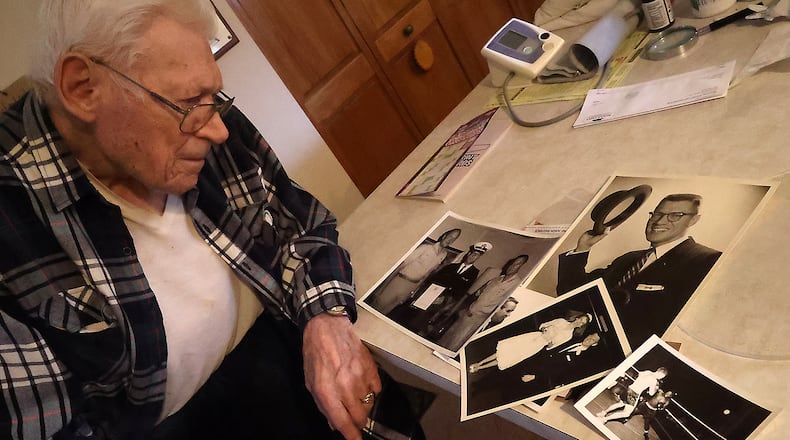 Gene Zeigler looks over some of the photos from his extraordinary life Wednesday, April 6, 2022. BILL LACKEY/STAFF