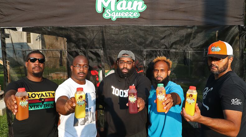 The owners of the Main Squeeze juice bar stand with some of their products, from left, Jafar Jones, Melvin Hardnick Jr, Earl Taylor, Marcus Clark and Craig Williams. BILL LACKEY/STAFF