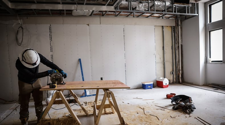A construction worker works on the Hilton Garden Inn that will be in the North Dayton Arcade in December 2024. The Ohio Department of Medicaid is getting ready to submit a request to the U.S. Centers for Medicare and Medicaid to impose work requirements on the Medicaid expansion group. JIM NOELKER/STAFF