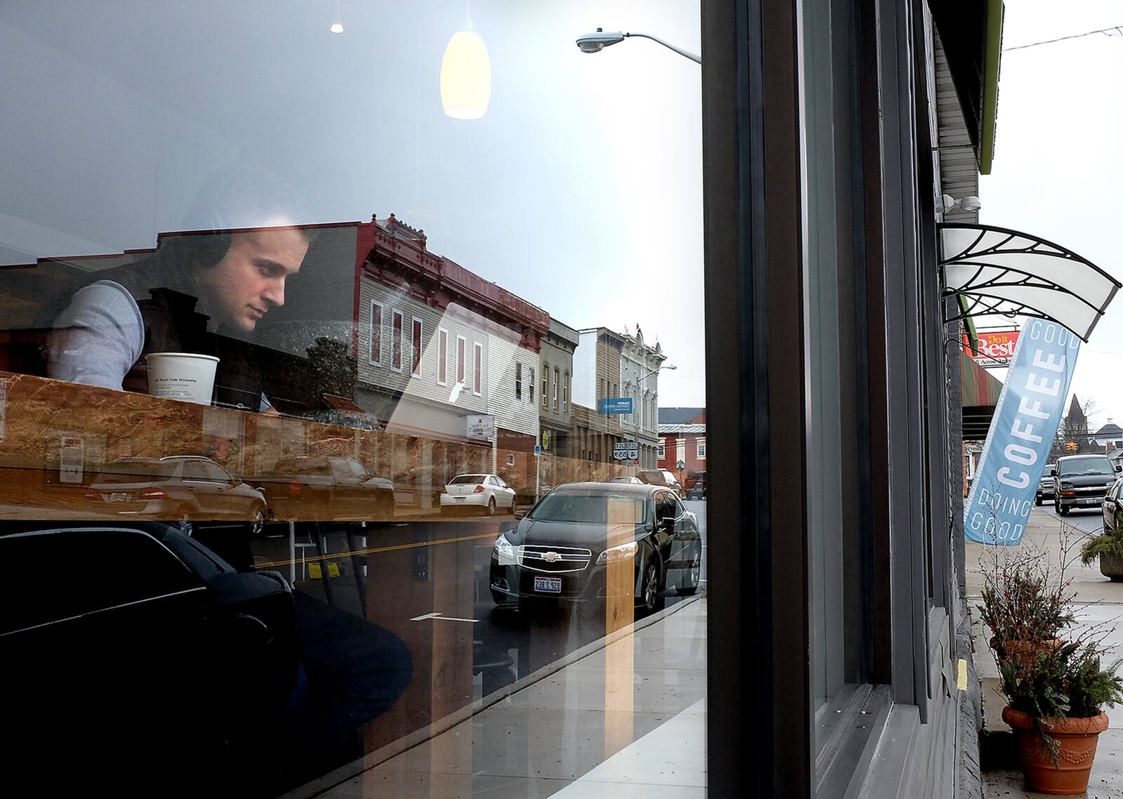 Dustin Timmerman is seen on his laptop in the front window of Hemisphere Coffee Roasters in downtown Mechanicsburg Tuesday, Jan. 3, 2017. Bill Lackey