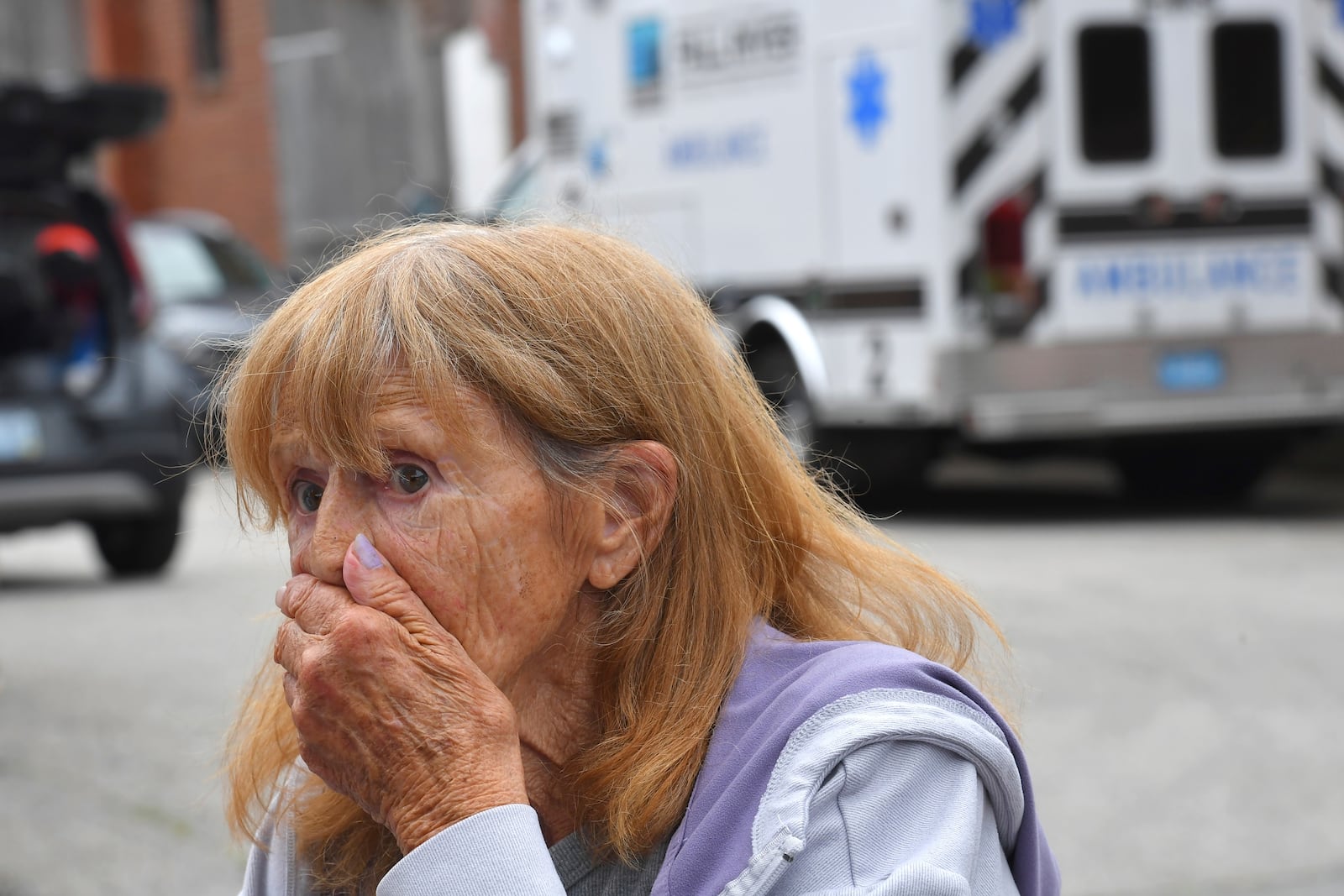 Donna Murphy, a resident at the Gabriel House assisted living facility, in Fall River, Mass., speaks with members of the media outside a temporary shelter, Monday, July 14, 2025, in Fall River, Mass., following a fire at the Gabriel House that started late Sunday and resulted in multiple fatalities. (AP Photo/Steven Senne)