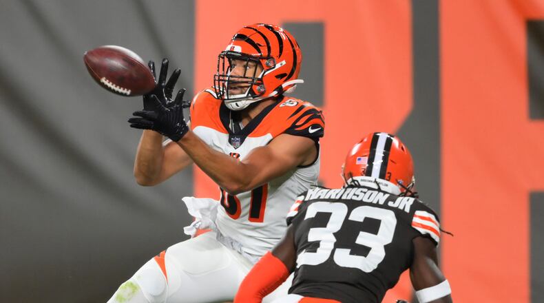 Cincinnati Bengals tight end C.J. Uzomah catches a touchdown pass next to Cleveland Browns' Ronnie Harrison Jr. during the first half of an NFL football game Thursday, Sept. 17, 2020, in Cleveland. (AP Photo/David Richard)