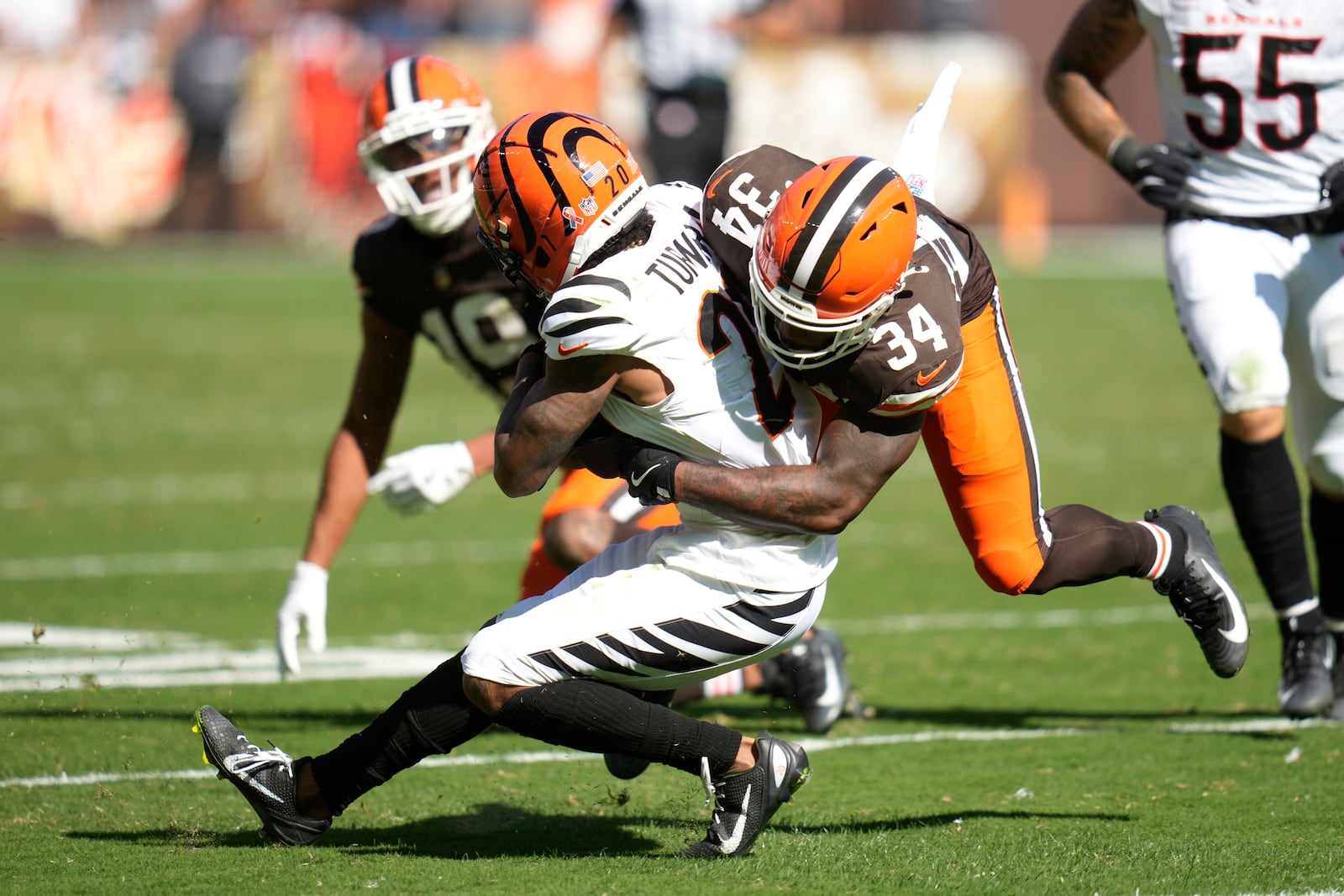 Cincinnati Bengals cornerback DJ Turner II (20) intercepts a pass during the second half of an NFL football game against the Cleveland Browns, Sunday, Sept. 7, 2025, in Cleveland. (AP Photo/Sue Ogrocki)