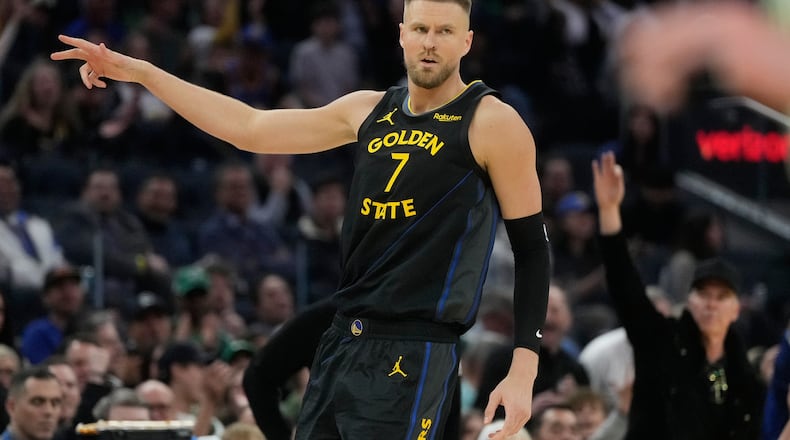 Golden State Warriors center Kristaps Porziņģis (7) gestures after making a 3-point basket during the first half of an NBA basketball game against the Boston Celtics in San Francisco, Thursday, Feb. 19, 2026. (AP Photo/Jeff Chiu)