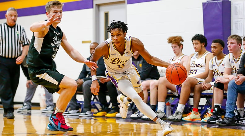 Cutline: Emmanuel Christian Academy senior Justus Channels dribbles past Catholic Central's Ian Galluch during their game earlier this season in Springfield. CONTRIBUTED PHOTO BY MICHAEL COOPER
