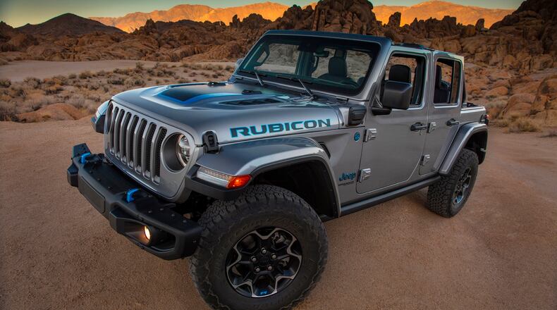 This photo provided by Fiat Chrysler shows the 2021 Jeep Wrangler Rubicon 4xe. Fiat Chrysler on Thursday, Sept. 3, 2020, unveiled the first of what it says will be many Jeeps powered by batteries. The Jeep Wrangler 4xe is the brand's first vehicle that can travel on electricity in the U.S. The gas-electric hybrid SUV can go 25 miles on battery power before a 2-liter, four-cylinder turbocharged engine takes over. (Fiat Chrysler via AP)