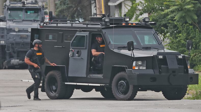 Members of the Springfield Police Division and other law enforcement agencies surrounded a house at the intersection of South Lowry Avenue and Fair Street Monday, June 6, 2022. The police fired tear gas into the residents and demanded that the man inside come out with his hands up. BILL LACKEY/STAFF