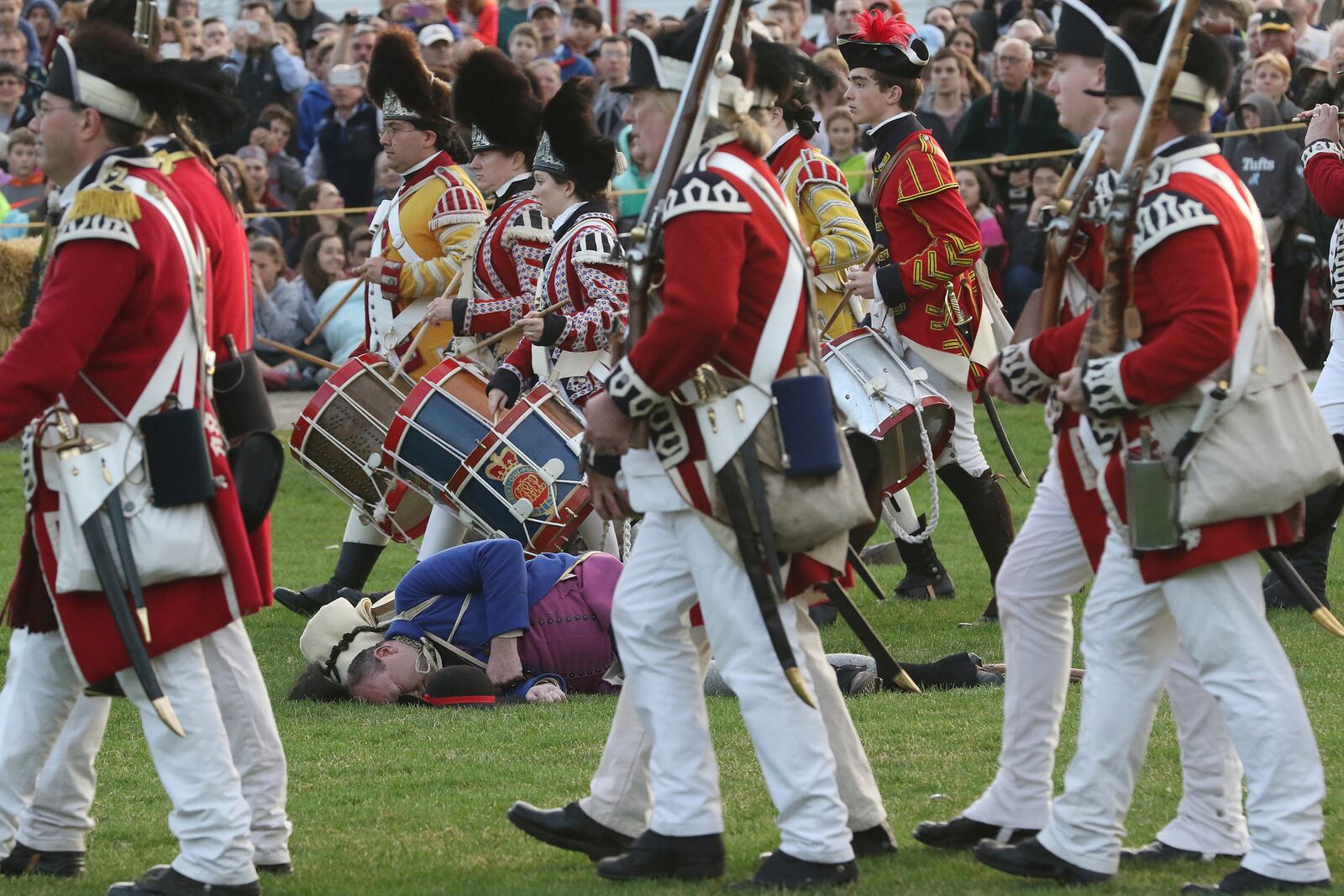 FILE - The British march off to Concord, leaving Lexington militia dead or dying on Lexington Green during a reenactment of the Battle of Lexington, Monday, April 17, 2017, in Lexington, Mass. (Ann Ringwood/The Metro West Daily News via AP,File)