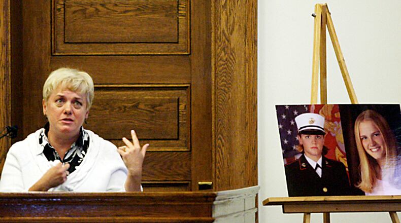 Mary Lauterbach testifies as images of her daughter, Marine Lance Cpl. Maria Lauterbach, sit next to the stand during the murder trial of Cesar Laurean in the Wayne County Superior Courthouse in Goldsboro, N.C. Associated Press photo by Troy Herring