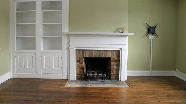 Just inside the front door is a space that could be used either as a family room or a formal dining room. This room features a wood-burning fireplace and built-in shelving and cabinetry.