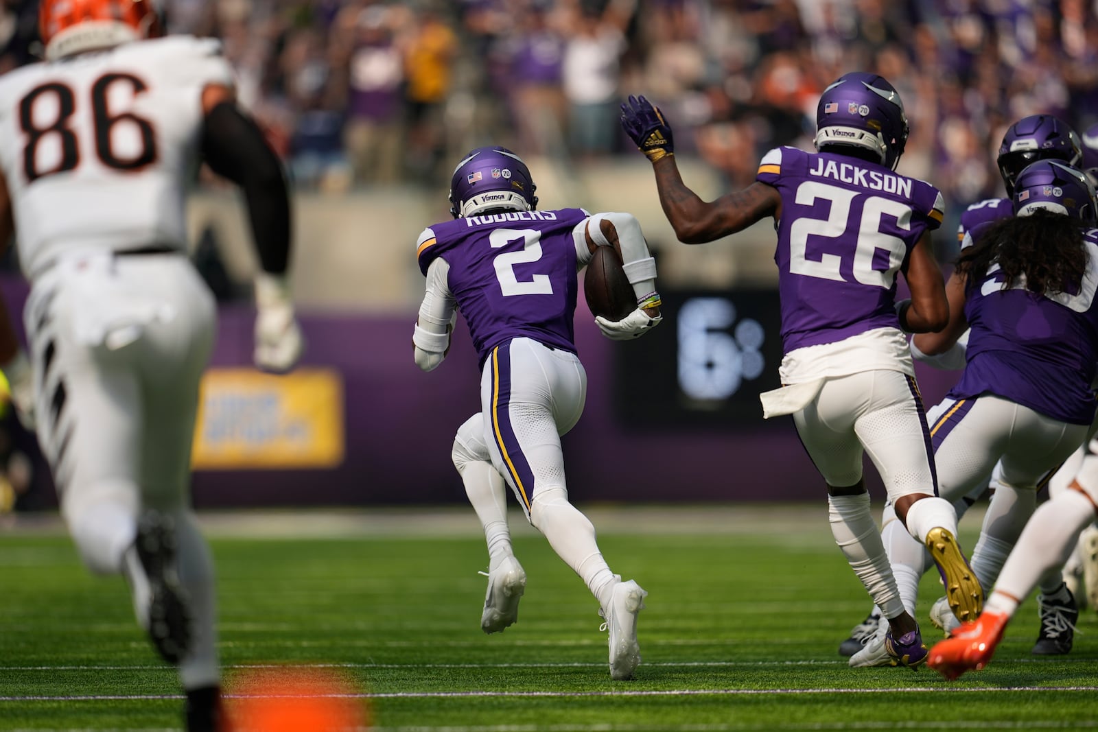 Minnesota Vikings cornerback Isaiah Rodgers (2) runs back an interception for a touchdown during the first half of an NFL football game against the Cincinnati Bengals, Sunday, Sept. 21, 2025, in Minneapolis. (AP Photo/Mike Stewart)