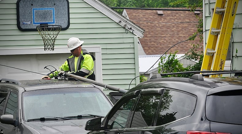 Ohio Edison Crews work to restore power on Seminole Avenue in Sunnyland in southwest Springfield after strong winds knocked down power lines and poles Sunday, May 26, 2024. MARSHALL GORBY \FILE