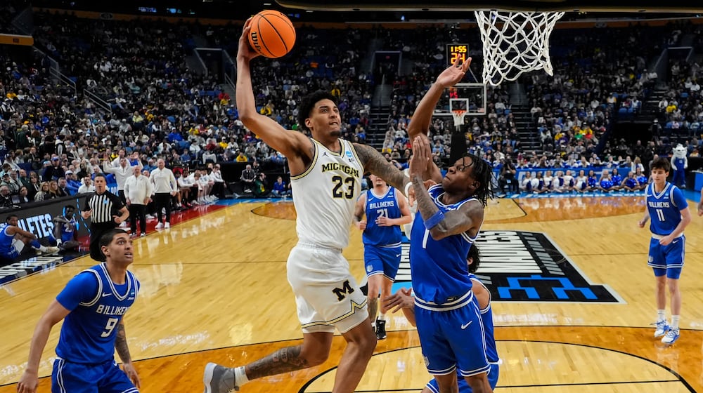 Michigan forward Yaxel Lendeborg (23) dunks over Saint Louis guard Quentin Jones (1) during the first half in the second round of the NCAA college basketball tournament, Saturday, March 21, 2026, in Buffalo, N.Y. (AP Photo/Yuki Iwamura)