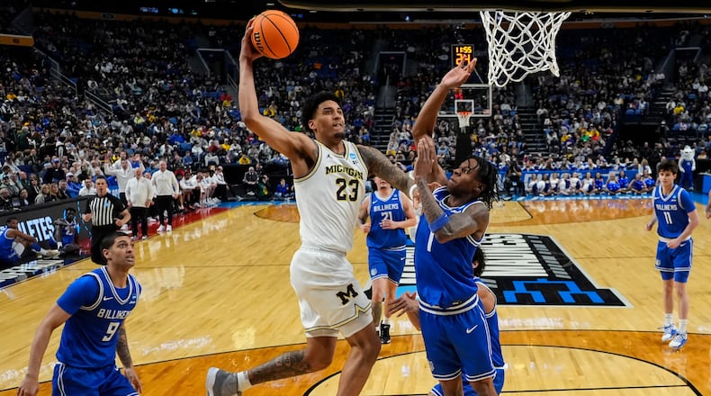 Michigan forward Yaxel Lendeborg (23) dunks over Saint Louis guard Quentin Jones (1) during the first half in the second round of the NCAA college basketball tournament, Saturday, March 21, 2026, in Buffalo, N.Y. (AP Photo/Yuki Iwamura)