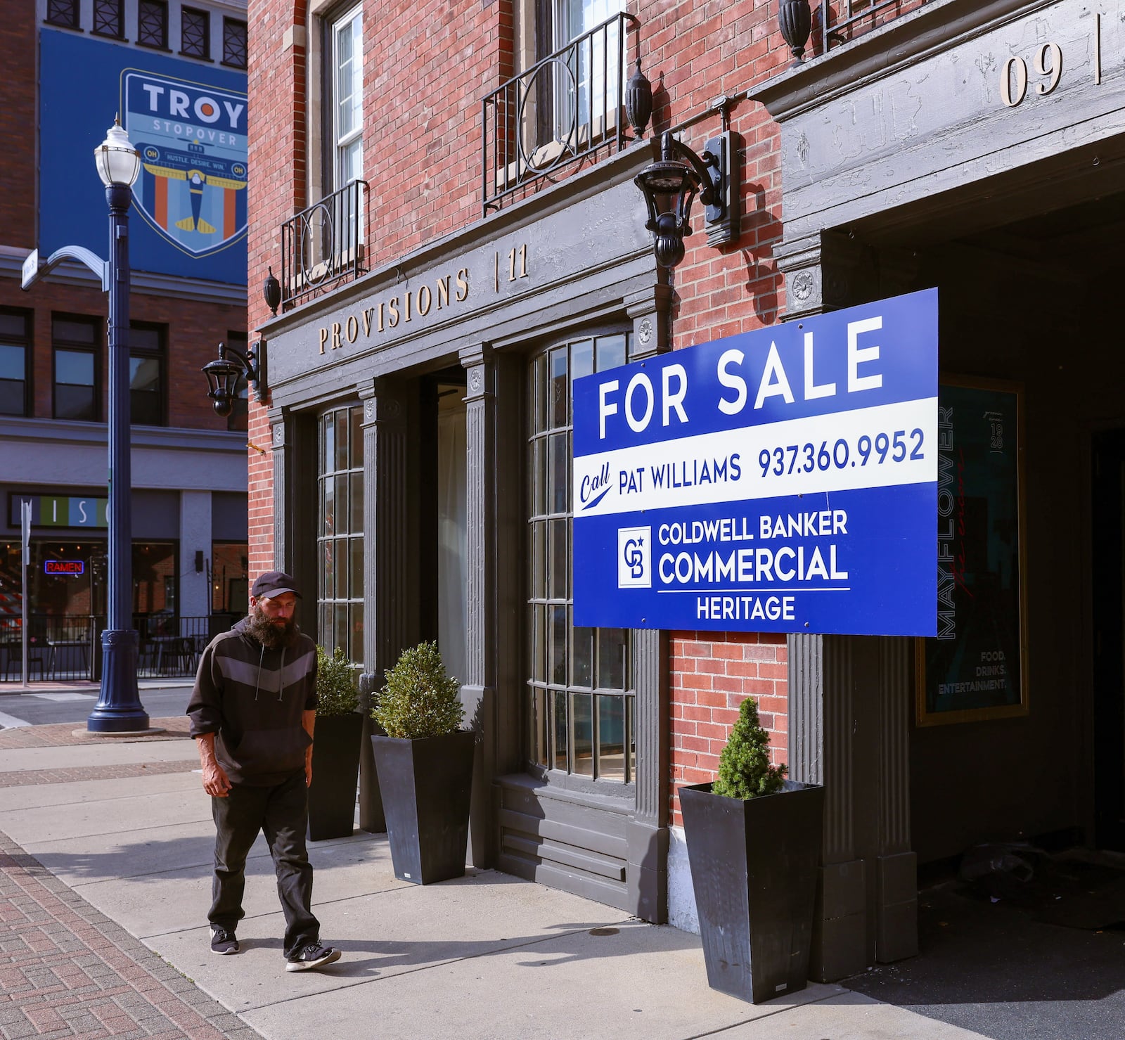 A man walks in front of the Mayflower building, which is located 9 W. Main St. in downtown Troy. The building is on the market for $2.915 million. One-time tenant Anthony "Tony" Scott Martin is facing felony and civil charges in conjunction with his business dealings. BRYANT BILLING / STAFF