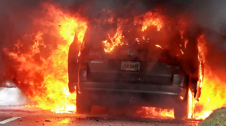 South Limestone Street was blocked Wednesday, Jan. 4, 2023, while the Springfield Fire Division extinguished a fully involved car fire in one of the southbound lanes. The driver escaped without injury. He said the van lost power so he stopped and it caught fire. BILL LACKEY/STAFF