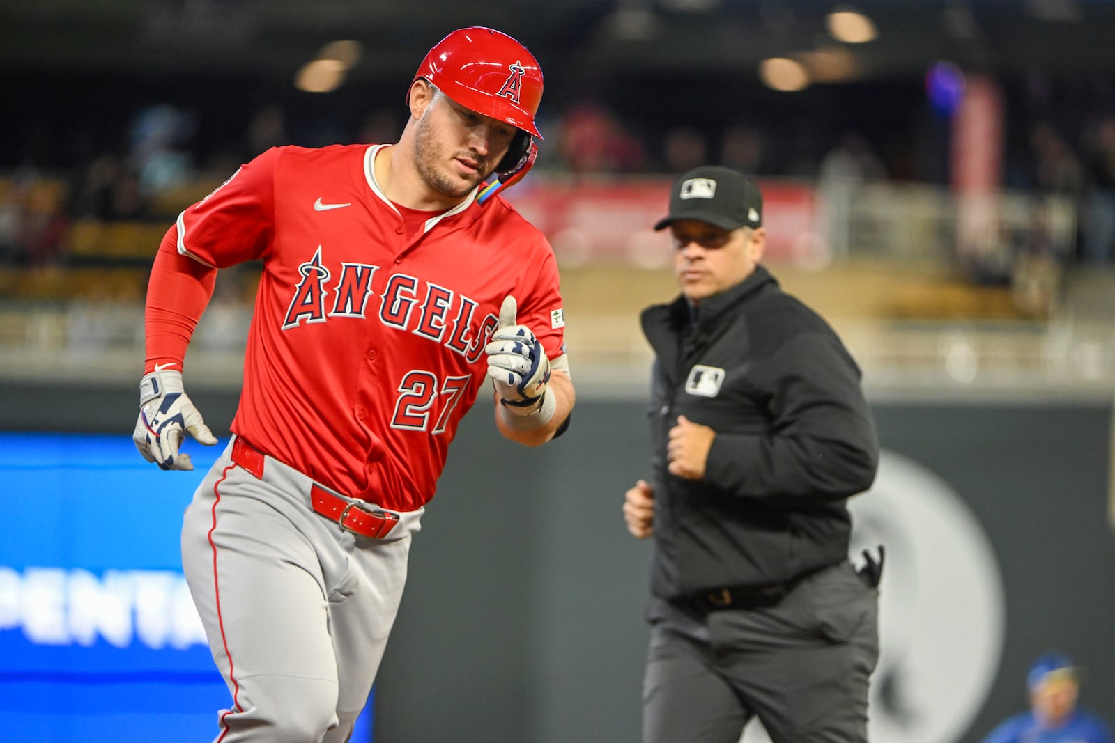 Los Angeles Angels' Mike Trout, left, rounds the bases after hitting a home run against the Minnesota Twins during the seventh inning of a baseball game, Friday, April 25, 2025, in Minneapolis. (AP Photo/Craig Lassig)