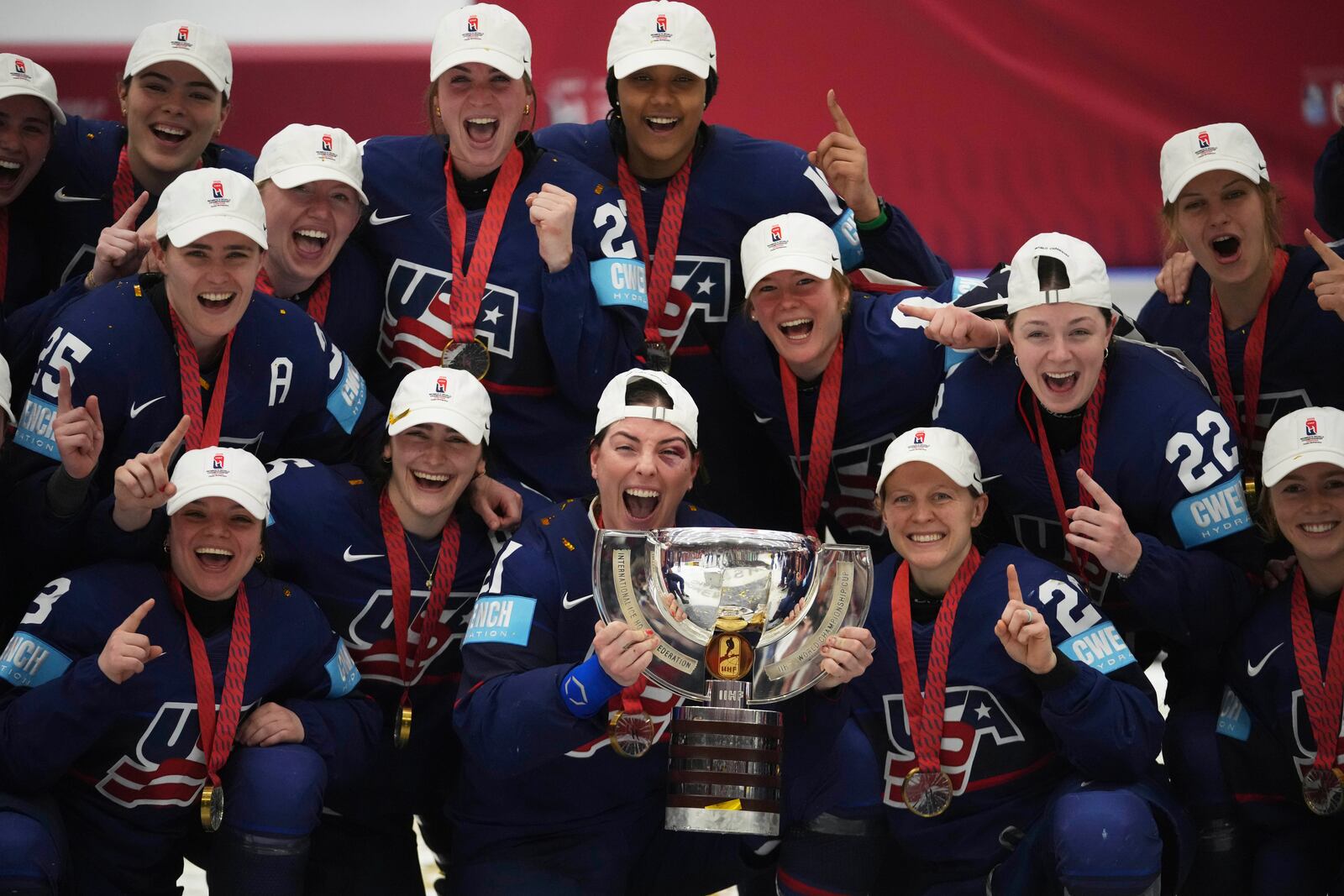United states players celebrate with a trophy after the gold medal match between Canada and United States at the Women's Ice Hockey Championships in Ceske Budejovice, Czech Republic, Sunday, April 20, 2025. (AP Photo/Petr David Josek)