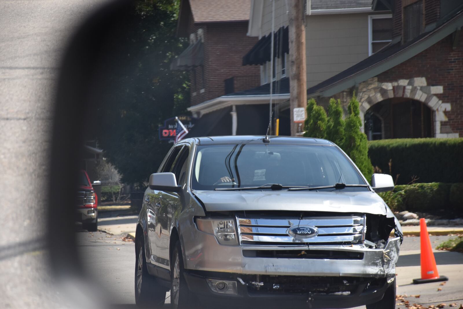 A Ford truck with front end damage drives on a Dayton area roadway. CORNELIUS FROLIK / STAFF
