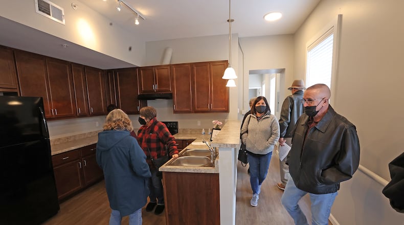 People tour the apartments and facilities during an open house at the new Legacy Place Monument Square Apartments in downtown Urbana Monday. The 55 and older apartments are located in the old Douglas Hotel, which has been totally renovated. BILL LACKEY/STAFF