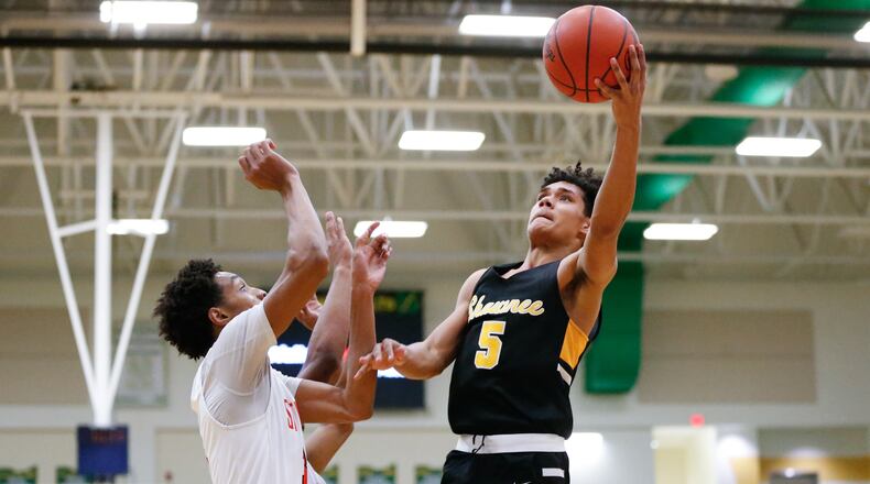 Shawnee High School junior Zion Crowe shoots the ball over two Stivers defenders during a tournament game last season at Northmont High School. CONTRIBUTED PHOTO BY MICHAEL COOPER