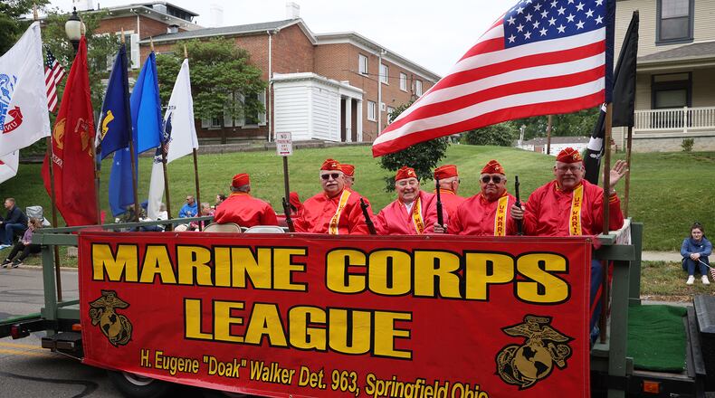 Hundreds of people cheered and waved flags along the streets of Springfield Monday morning as the annual Memorial Day Parade resturned after being canceled last year do to COVID-19. BILL LACKEY/STAFF