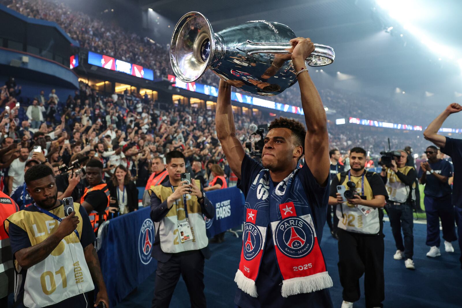 Paris Saint-Germain's midfielder Desire Doue celebrates with supporters during a ceremony to present the trophy a day after Paris Saint-Germain (PSG) won the UEFA Champions League, at the Parc des Princes Stadium in Paris Sunday, June 1, 2025. (Franck Fife, Pool via AP)