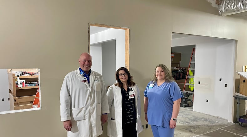 Lead pharmacist Chris Patsiavos, clinical pharmacist Ashlee Leaver and technician Amanda Castle are shown as construction is underway for the Mercy Health - Urbana Hospital pharmacy. CONTRIBUTED