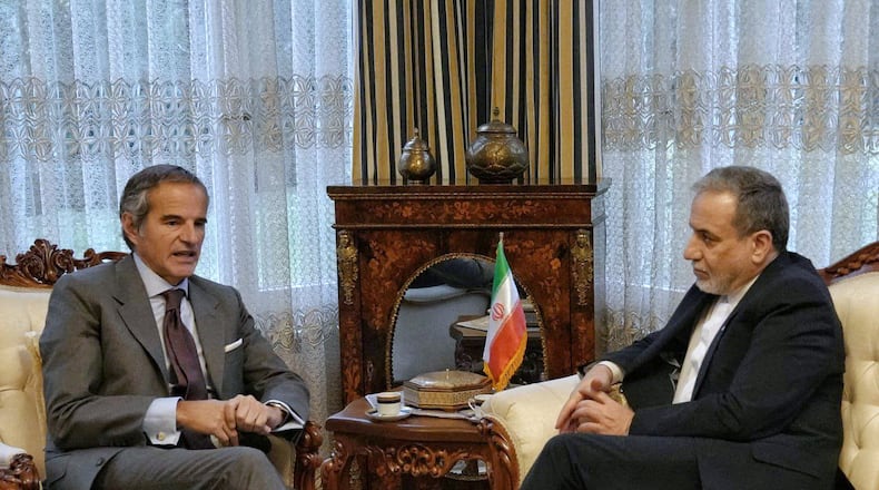 In this photo released by the Iranian Foreign Ministry, Iranian Foreign Minister Abbas Araghchi, right, and International Atomic Energy Agency (IAEA) Director-General Rafael Grossi, left, hold a meeting in Geneva, Switzerland, Monday, Feb. 16, 2026. (Iranian Foreign Ministry via AP)