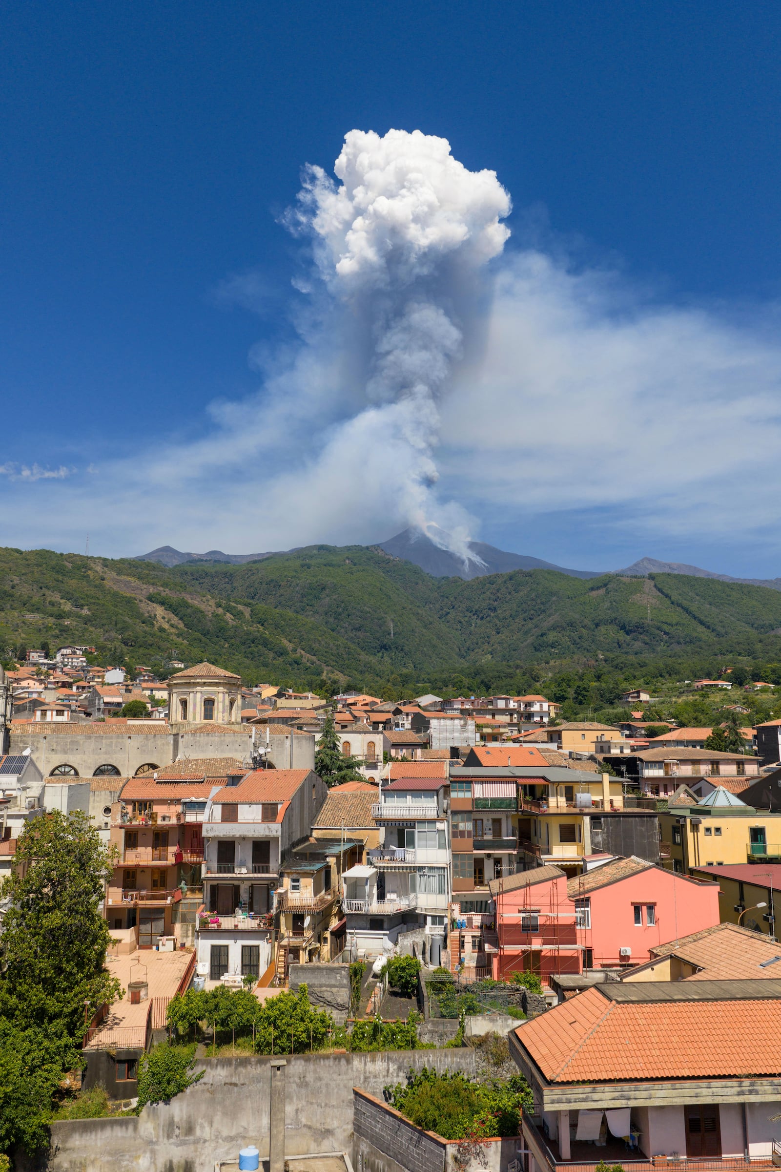 Smoke billows from Mount Etna volcano, seen from the village of Zafferana Etnea, Italy, Monday, June 2, 2025. (AP Photo/Giuseppe Distefano)