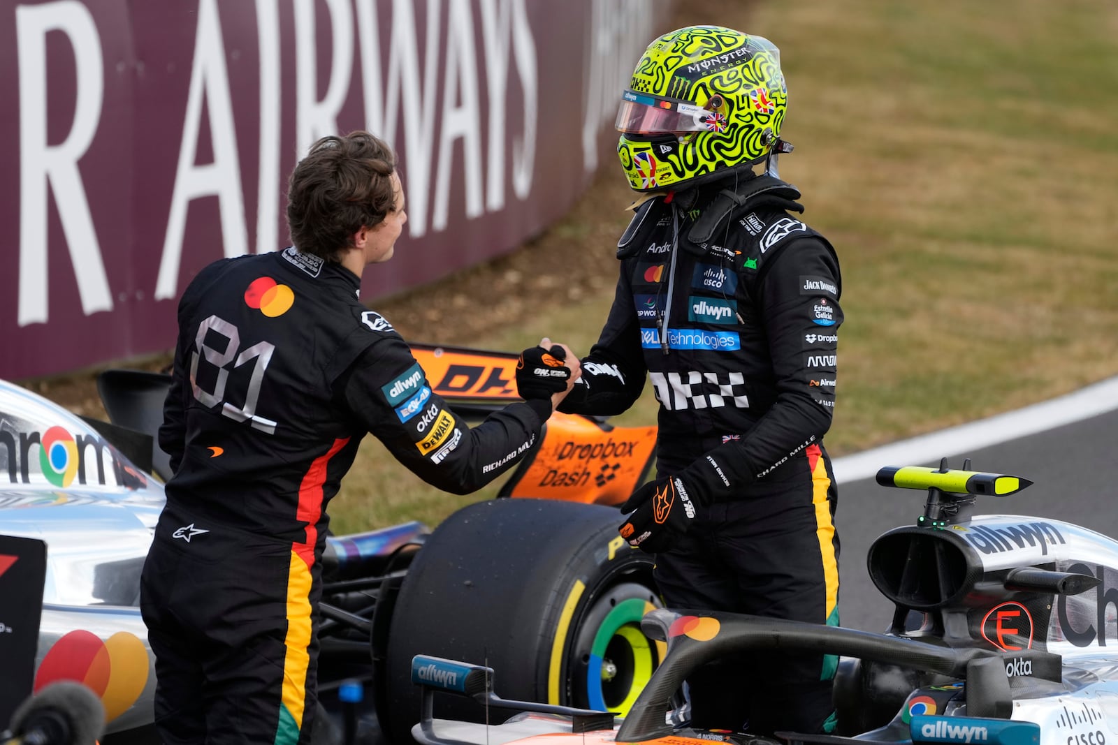 McLaren driver Lando Norris of Britain, right, is congratulated by his teammate Oscar Piastri of Australia after winning the British Formula One Grand Prix race at the Silverstone racetrack in Silverstone, England, Sunday, July 6, 2025. (AP Photo/Darko Bandic)