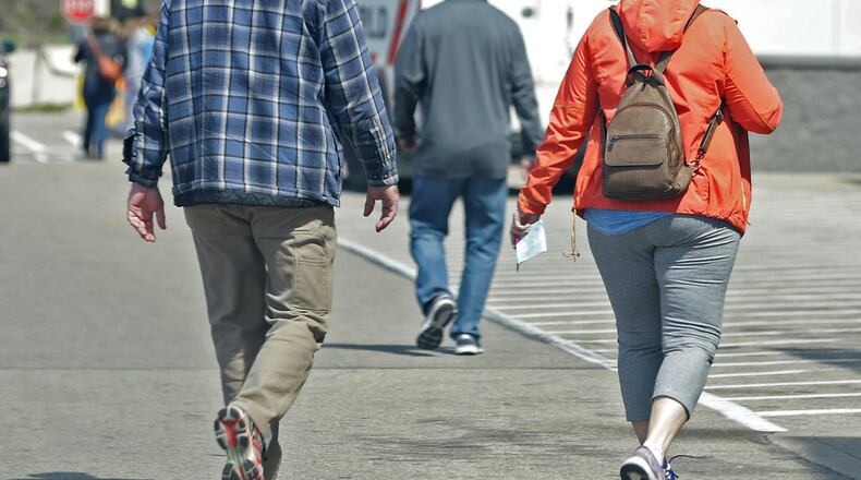 People walk in and out of a Springfield store Thursday. BILL LACKEY/STAFF
