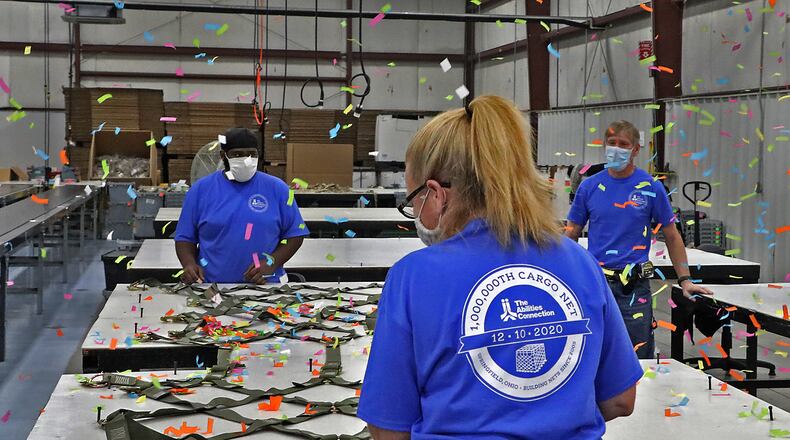Confetti canons go off as The Abilities Connection finishes inspection of their one millionth cargo net for the United States Military Thursday at their Springfield plant. BILL LACKEY/STAFF