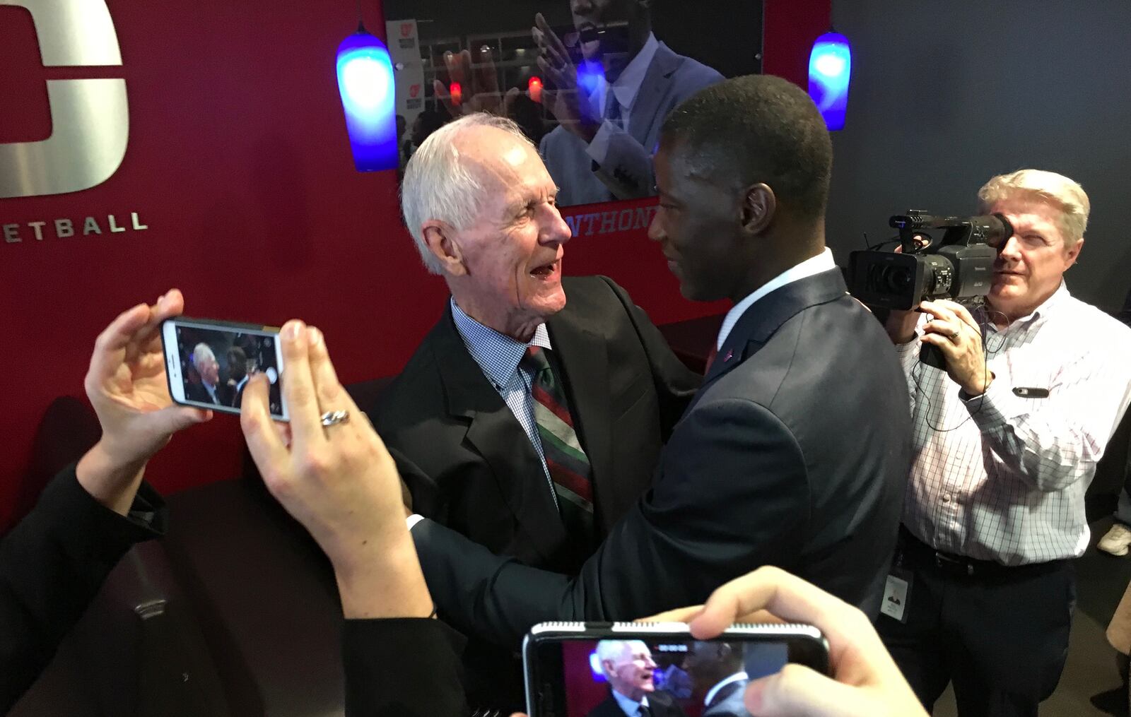 Don Donoher and Anthony Grant hug after his introductory press conference Saturday at UD Arena. David Jablonski/Staff